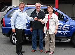 Richard Murrell of Southland Vehicle Sales handing the over the keys to a new KIA Sportage to Barbara MacDonald and her husband Stan.